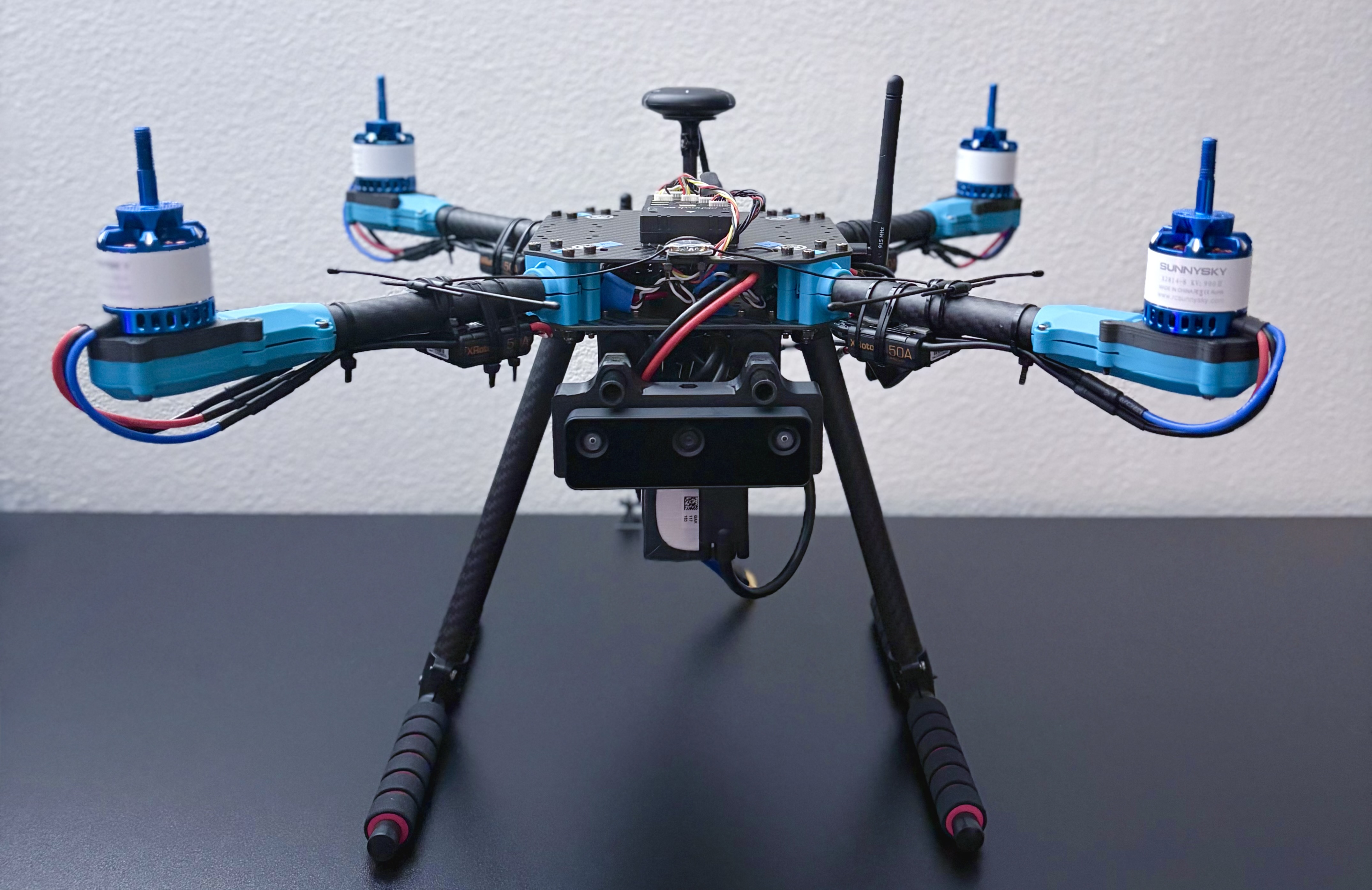 The assembled quadrotor: Holybro X500 frame with the stereo camera mounted below the front and the Jetson enclosure between the plates.